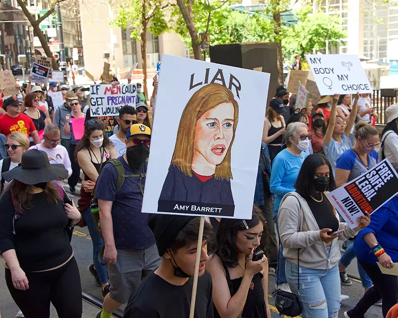 Protesters marching in the streets in support of abortion rights. - Shutterstock