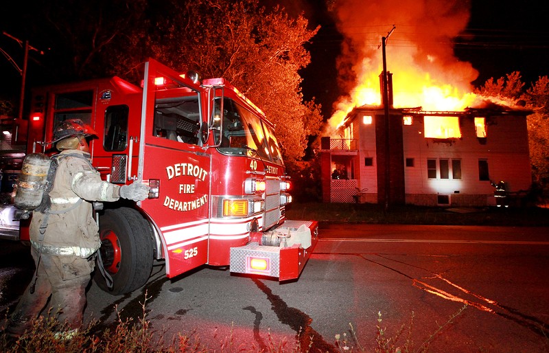 A Detroit firefighter battles a blaze. - Shutterstock