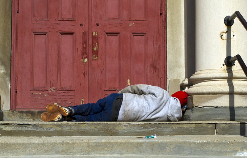 A man sleeps on the steps of a church in Detroit. - Steve Neavling