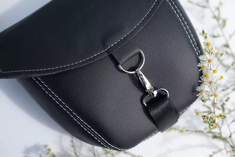 A convertible cross-body bag and backpack that, in its former life, was a headrest for a Ford Explorer. - Hannah Steppey