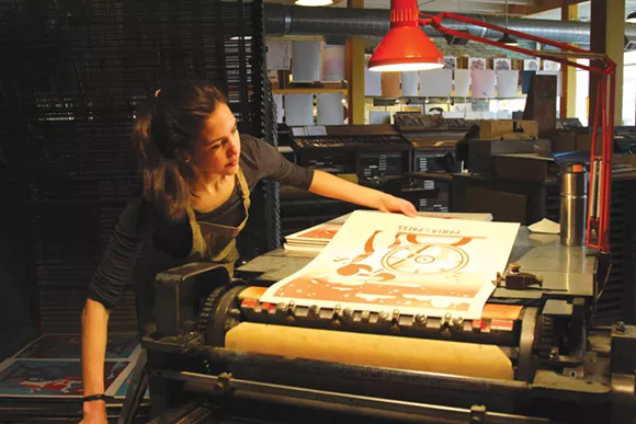 Sophia Pappas prints her poster for Power of the Press Fest at Eastern Market’s Signal-Return. - Sarah Rahal