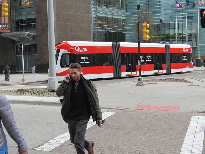 The QLine streetcar passes by in downtown Detroit. - Shutterstock