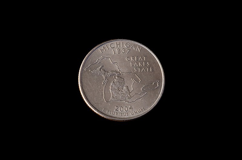 A quarter emblazoned with an image of Michigan. - Shutterstock