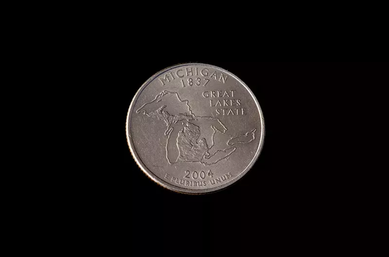 A quarter emblazoned with an image of Michigan. - Shutterstock