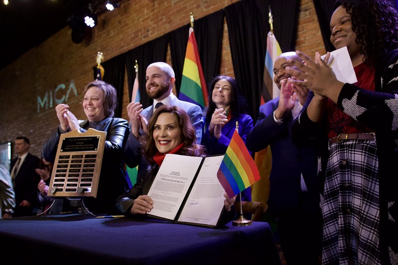 Gov. Gretchen Whitmer signs a bill expanding the state's civil rights act to protect LGBTQ people. - State of Michigan