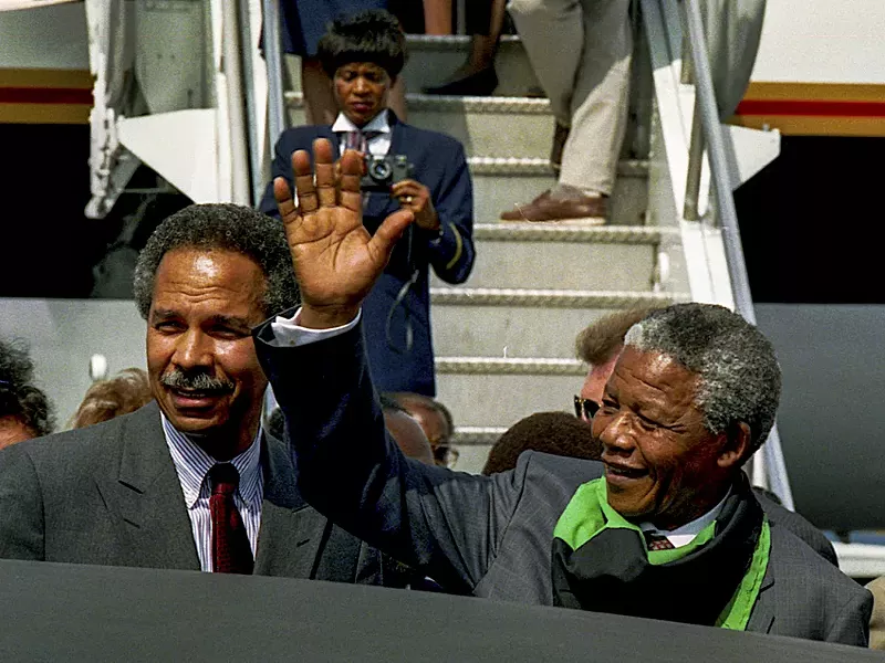 Randall Robinson greets Nelson Mandela in Washington, D.C. in 1990. - Shutterstock