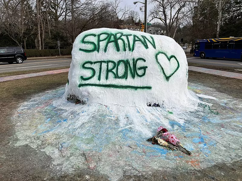 A memorial painted on the University of Michigan campus honors the victims of the MSU shooting. - Shutterstock