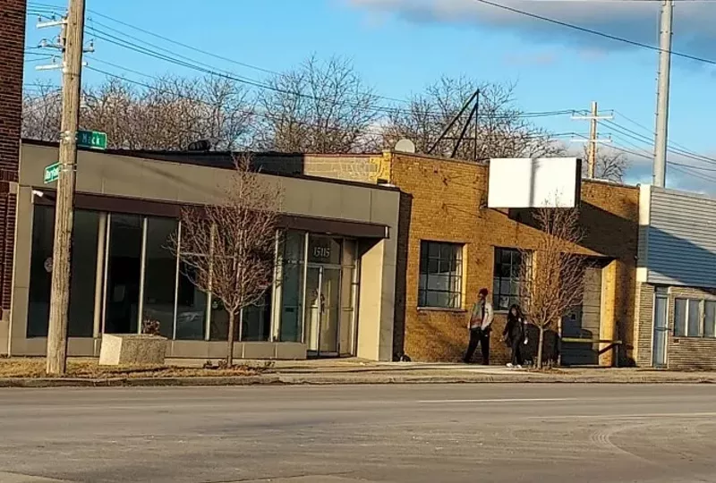 Patrick Giroux's building and his sign before it was removed by the city of Detroit. - Patrick Giroux