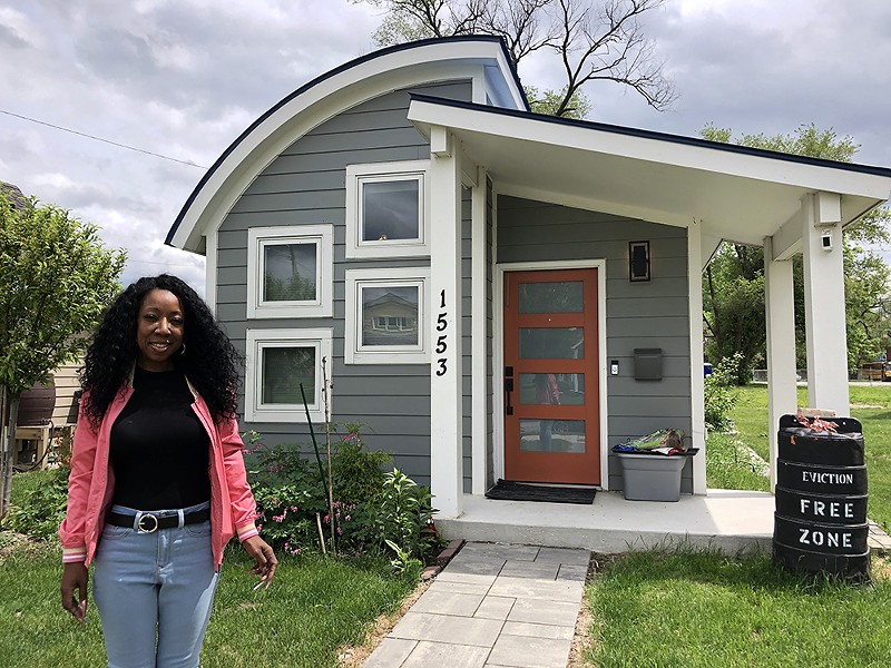 Taura Brown outside her tiny home in Detroit before her eviction. - Steve Neavling