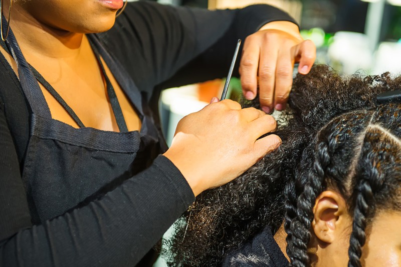 The CROWN Act will protect against discrimination on hair texture and race-based hairstyles, including but not limited to braids, dreadlocks, twists, and Afros. - Shutterstock