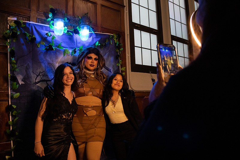 Queer prom attendees pose with drag performer Jezebel’s Inferno. - Quinn Banks