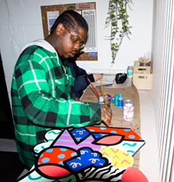 Detroit artist Sheefy McFly working on a project at a previous Art Night. - Woobenz Deriveau