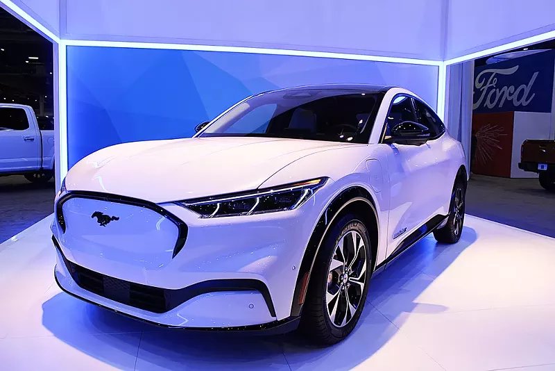 The electric Ford Mustang Mach-E on display at an auto industry show. - Shutterstock