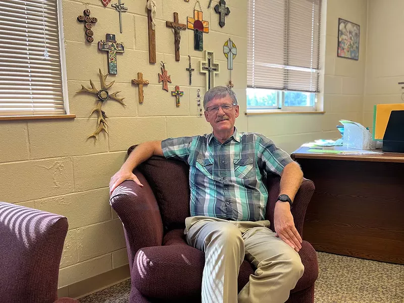 Pastor Bill Uetricht poses for a photograph at First Lutheran Church in Muskegon. The church has a solar array up and running. - Izzy Ross/IPR News