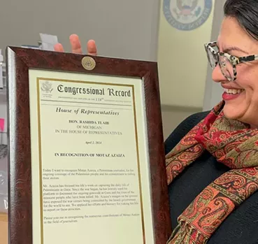 Tlaib presented Azaiza with a plaque of recognition for his journalism work in Gaza. - Instagram, @motaz_azaiza