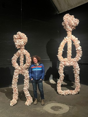 Detroit artist Laura Quattrochi standing next to human figures made of Lotto tickets for "The Loser Show" at Andy Arts. - Layla McMurtrie