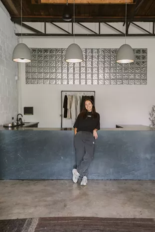 Hot Bones founder Lara Richli stands in front of the studio’s broth bar. - Christina Stoever