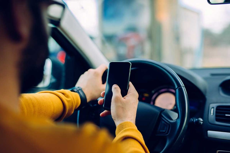 In Michigan, using a cell phone while driving is illegal. – Shutterstock