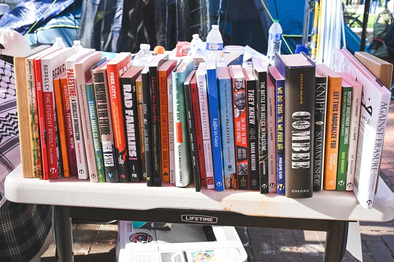 A small library (the “Liberation Library”) at the U-M protest encampment features books, pamphlets, and other forms of media describing the history of Israel and Palestine. - Doug Coombe