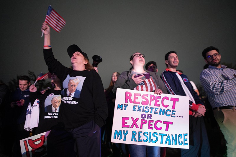 Supporters react as they listen to Donald Trump’s speech live on the radio outside of Drake Enterprises, an automotive supplier in Clinton Township in Macomb County. - Mark Bialek/ZUMA Press Wire