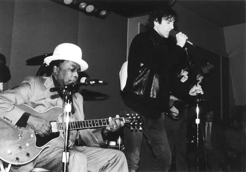 Wolf performs with John Lee Hooker, circa 1987. - Courtesy of JohnBoy Franklin