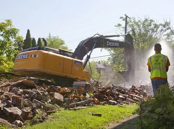 The Detroit Land Bank knocks down a dilapidated house on the city’s west side in September 2015, when Detroit averaged 150 demolitions a week. - Steve Neavling