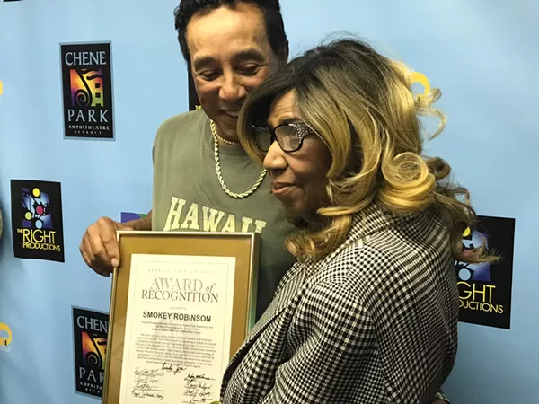 Aretha Franklin presents a City of Detroit Award of Recognition to Smokey Robinson before his performance at Chene Park Amphitheater. - David E. Rudolph