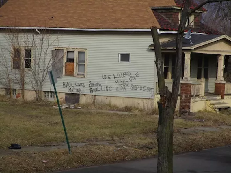A house on Concord Avenue, a block-and-a-half away from U.S. Ecology, bears complaints about the nearby toxic waste facility: "US. E KILLERS ... MDEQ SOLD US OUT." - Photo by Michael Jackman
