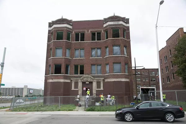 Crews on site at 2447 Cass, which housing preservationists say is slated for demolition.