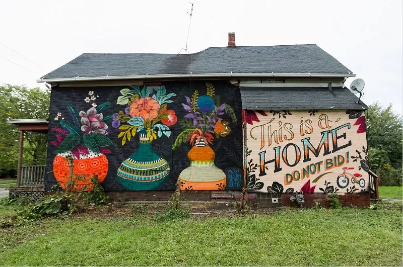 A message painted on a foreclosed Detroit home aims to make it easier for the family inside to buy it at auction. - Michele Oberholtzer