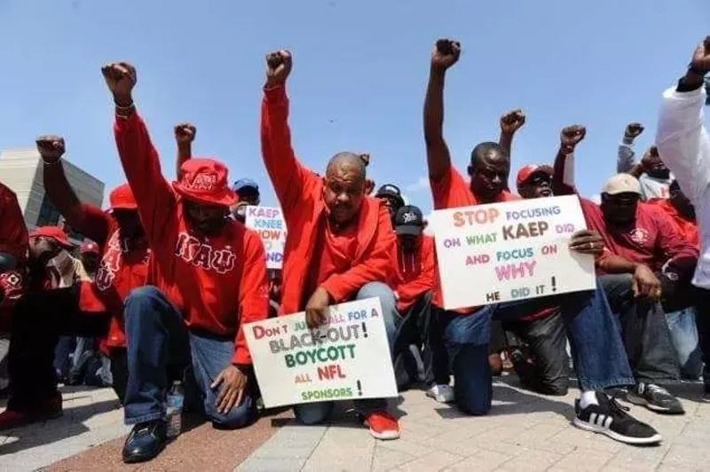 Detroit area members of Colin Kaepernick’s Kappa Alpha Psi fraternity kneel outside Ford Field during a demonstration in September. - Courtesy Photo