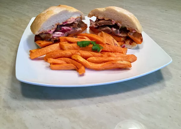 Pan con chicharron and sweet potato fries. - Courtesy photo