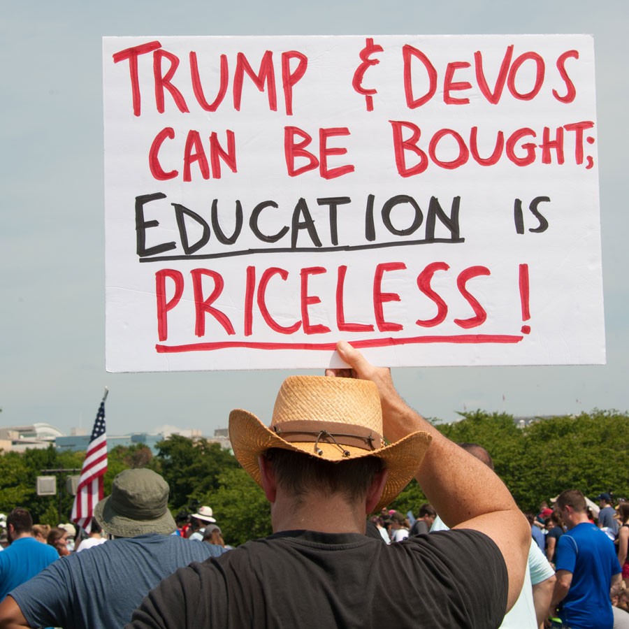 A demonstrator holds a sign at the March for Education in July 2017. - RENA SCHILD