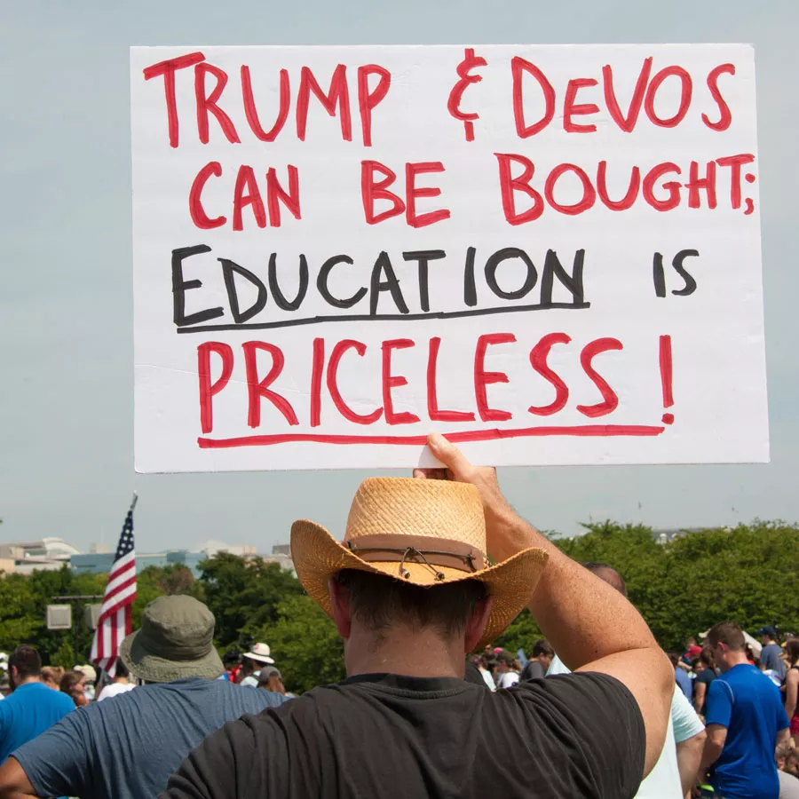 A demonstrator holds a sign at the March for Education in July 2017. - Rena Schild