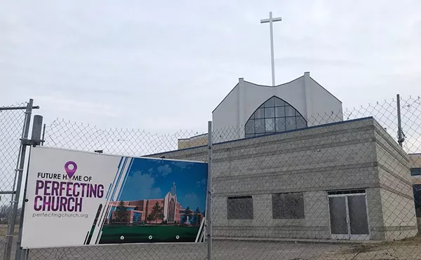A sign at Detroit’s 18-year Perfecting Church development shows expectations versus reality.
