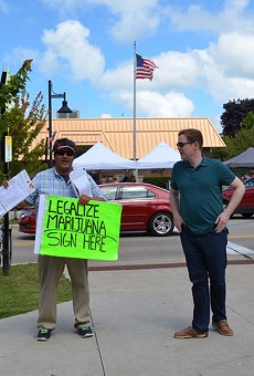 An activist encourages visitors to the National Blueberry Festival in downtown South Haven to sign a petition to legalize marijuana in Michigan.
