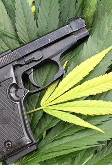 On the federal level, marijuana is still illegal, and it's a felony punishable by up to 10 years in prison to smoke pot and buy or own a gun.