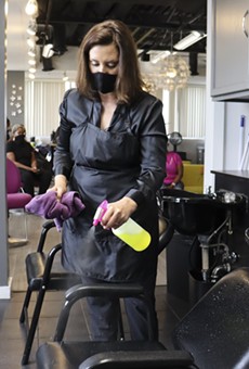 Gov. Gretchen Whitmer at Reflections Hair Salon in Grand Rapids, where she helped clean equipment.