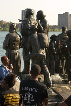 Black activists rally against racism next to an Underground Railroad monument in Hart Plaza in Detroit.