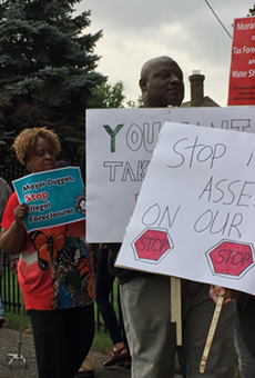Protesters call on the Wayne County Treasurer to halt the auction until the problem of "illegal tax assessments" can be resolved.