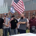 Without a trace of irony, a man flashes a white supremacist symbol among pro-Israel Trump supporters in front of the Holocaust Memorial Center