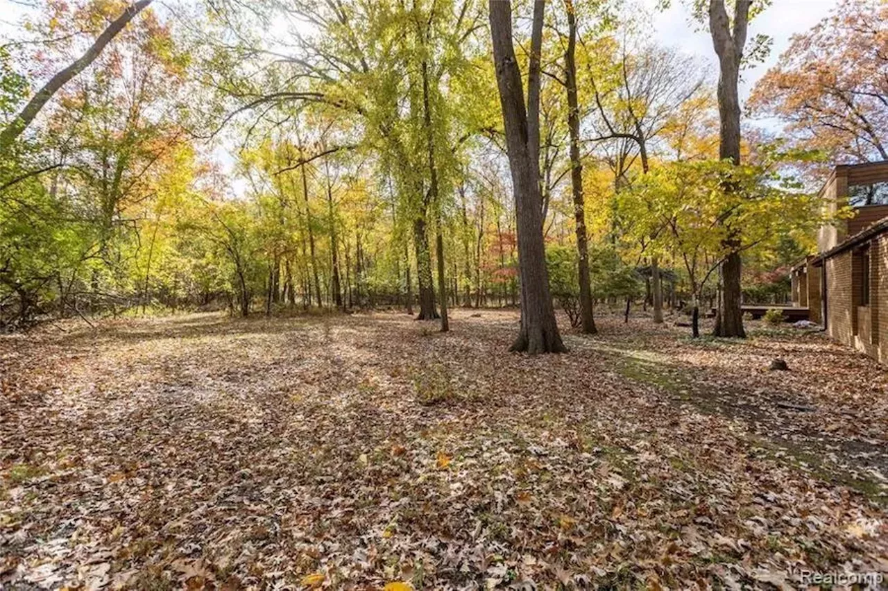 This custom 649k home in Grosse Ile has a fabulous conversation pit