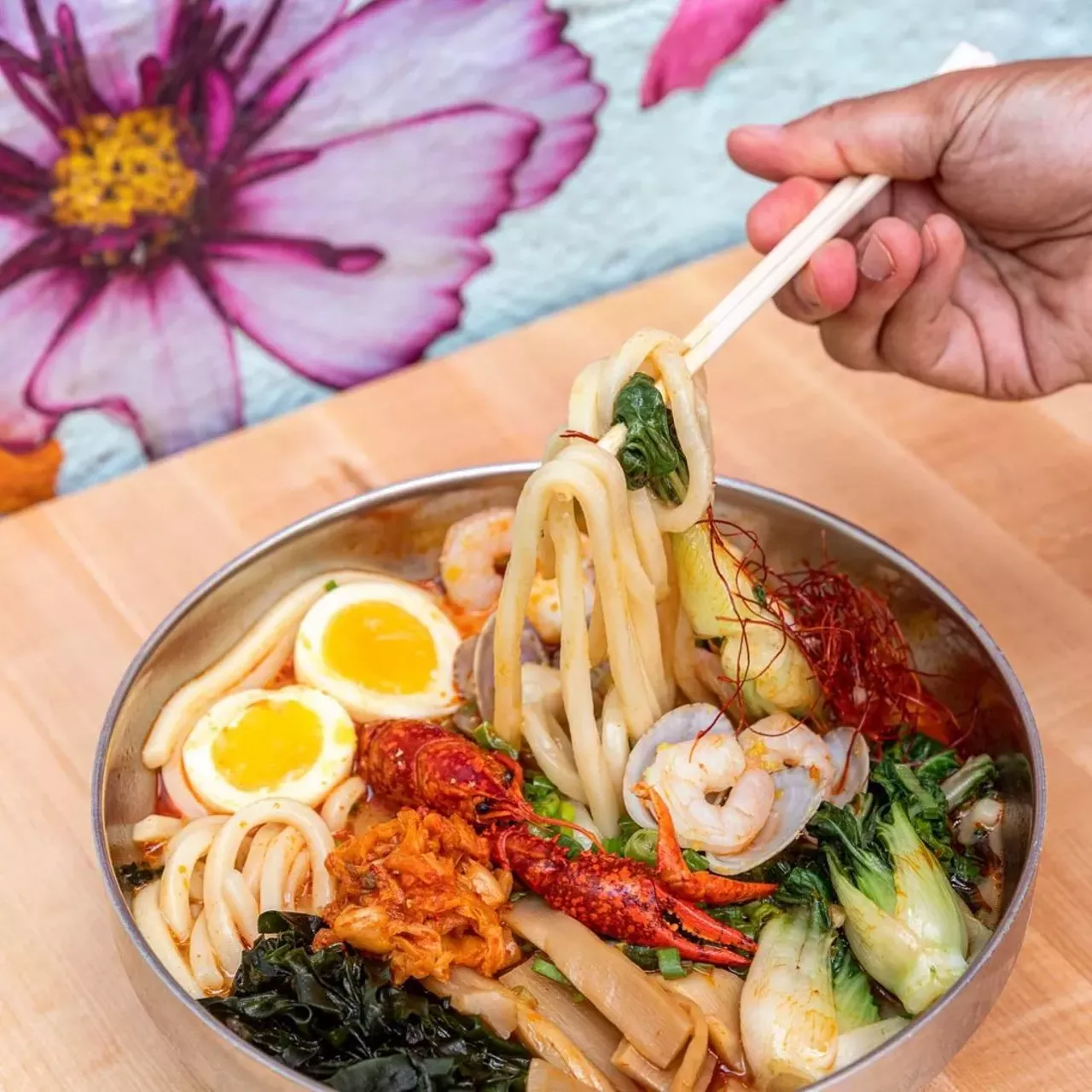 Ima
32203 John R Rd., Madison Heights; 4870 Cass Ave., Detroit; 313-502-5959 imanoodles.com
So noodle and rice stop may not be fancy smancy, but Ima was voted Detroit's best restaurant by The Detroit Free Press when it opened its flagship location in Corktown. Though Ima&#146;s Corktown location is closed, their Midtown and Madison Heights outposts are offering curbside takeout with a limited menu with all the favorites. Warm up with a golden curry rice bowl, boombap, unagi-don, or noodle dishes spanning yaki udon varieties, and miso, forest, shoyu, and spicy tori ramen. Their latest creation, a spicy twice-fried crispy boneless chicken sandwich, boasting ginger, soy, sake, and garlic flavors is also available. Thirsty? They've got sake, wine, and beer to-go, too. 
Photo via Ima/Facebook