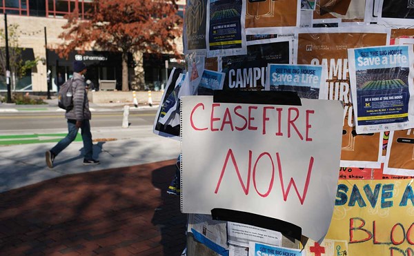 “Ceasefire Now” handwritten sign on a kiosk in downtown Ann Arbor.