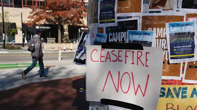 “Ceasefire Now” handwritten sign on a kiosk in downtown Ann Arbor.