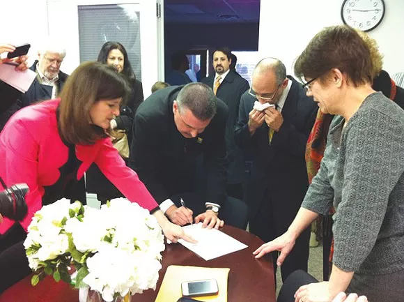 James Ryder, 48, and Frank Colasonti, 61, the first same-sex couple married at Oakland County Circuit Court Saturday, March 22, make it official with County Clerk Lisa Brown and their two witnesses, Jan Stevenson, publisher of Between the Lines, and Susan Horowitz. - Ryan Felton/Metro Times