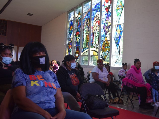 Benton Harbor residents gather inside God’s Household of Faith church Saturday.