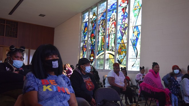 Benton Harbor residents gather inside God’s Household of Faith church Saturday.