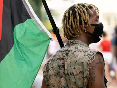 A person with a Pan-African flag.