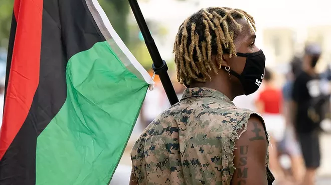 A person with a Pan-African flag.